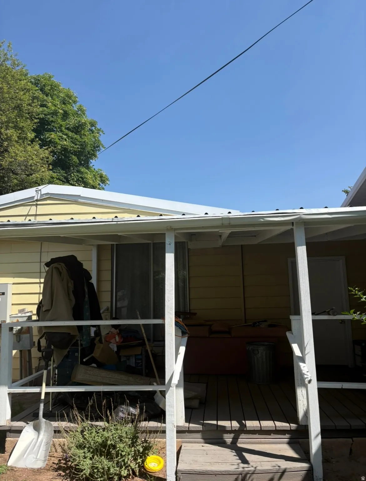 Back of property with a deck and a sunroom