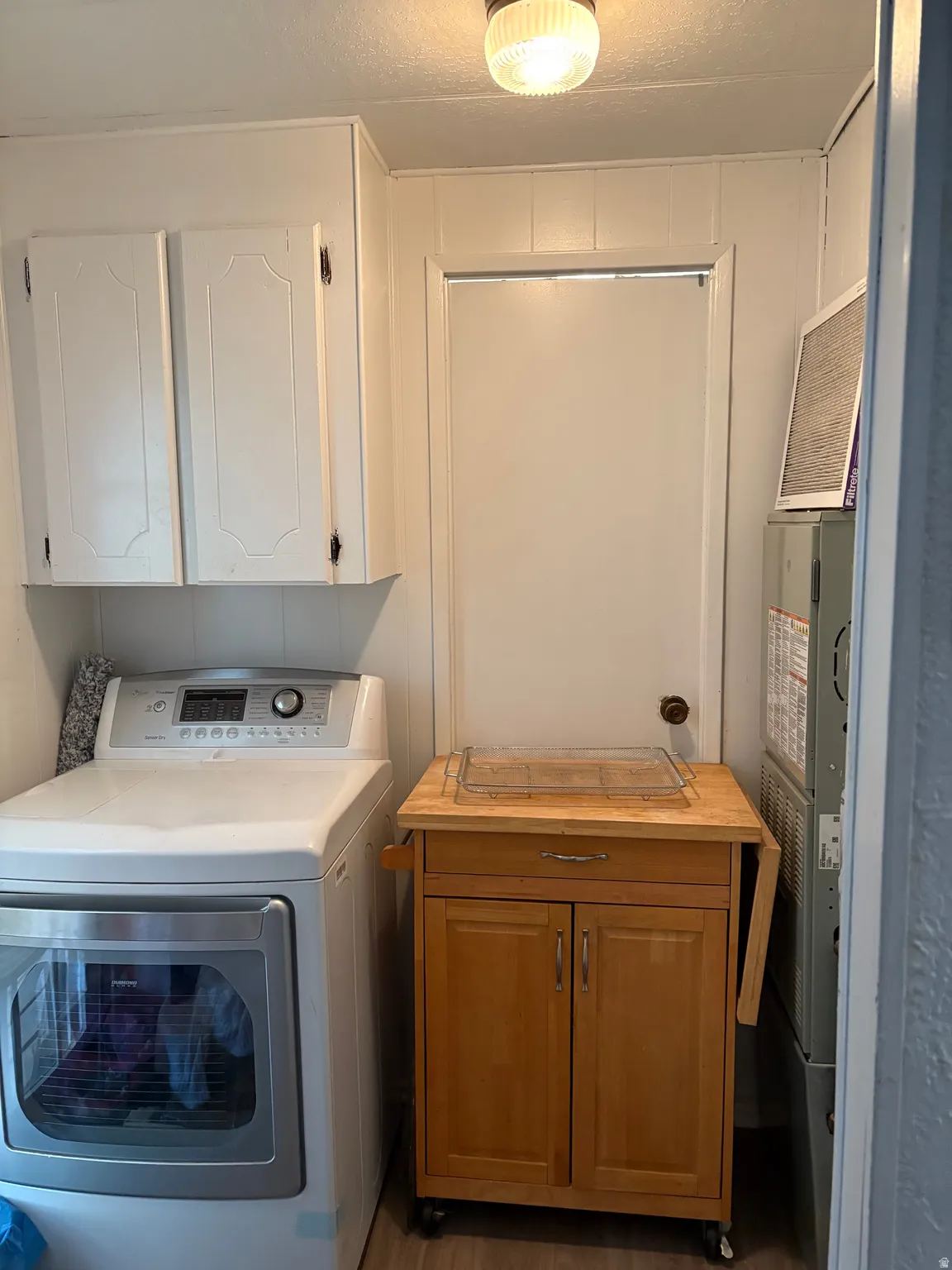 Laundry room featuring washer / dryer and cabinet space