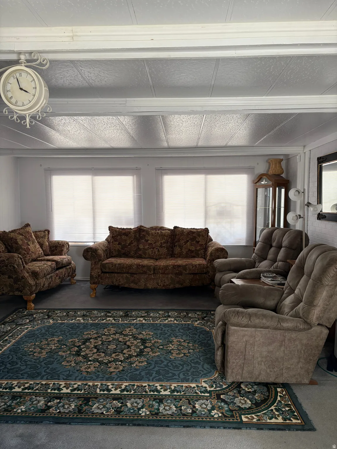 Living area with plenty of natural light and carpet flooring