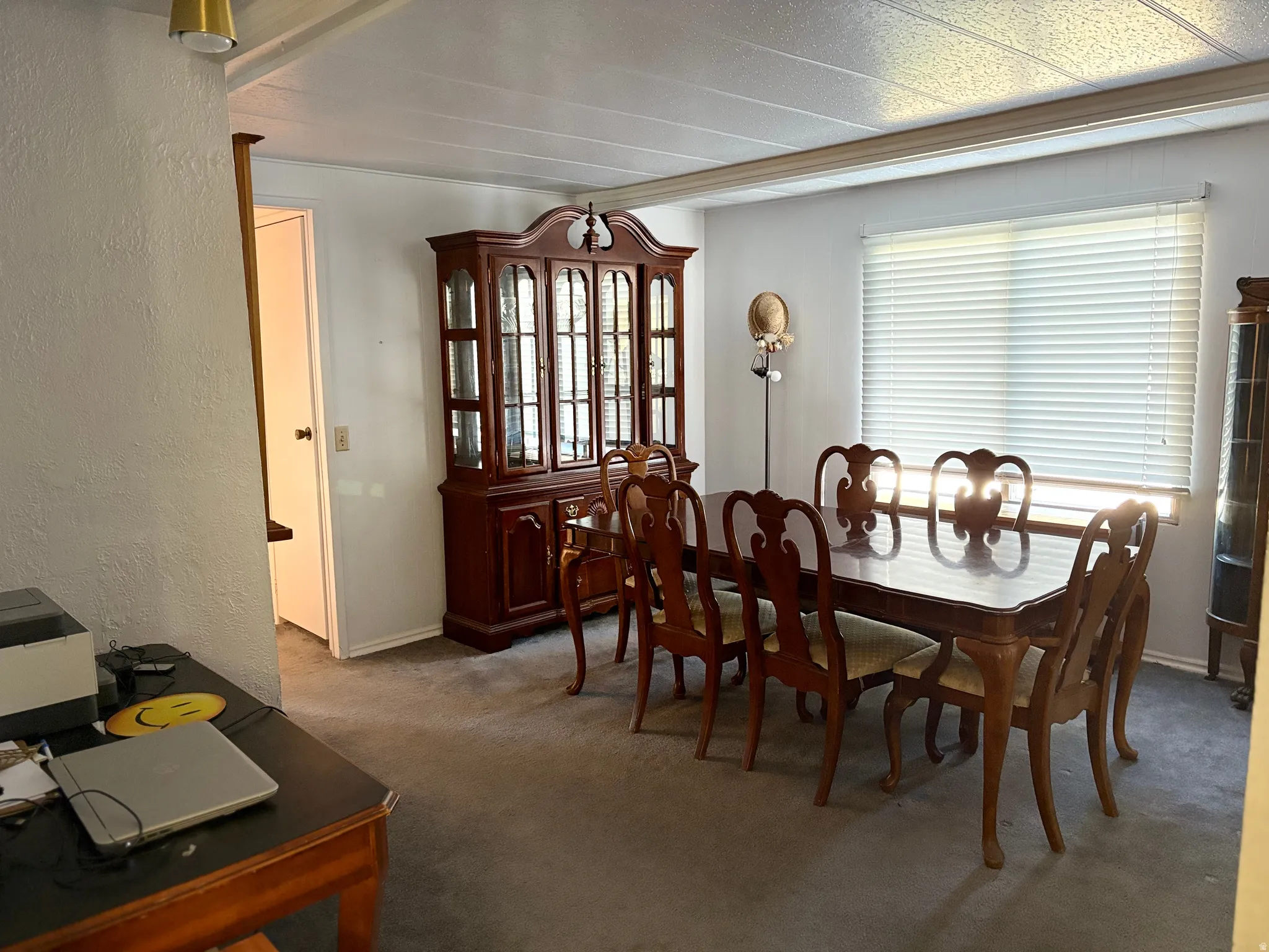 Dining room featuring carpet floors and a textured wall