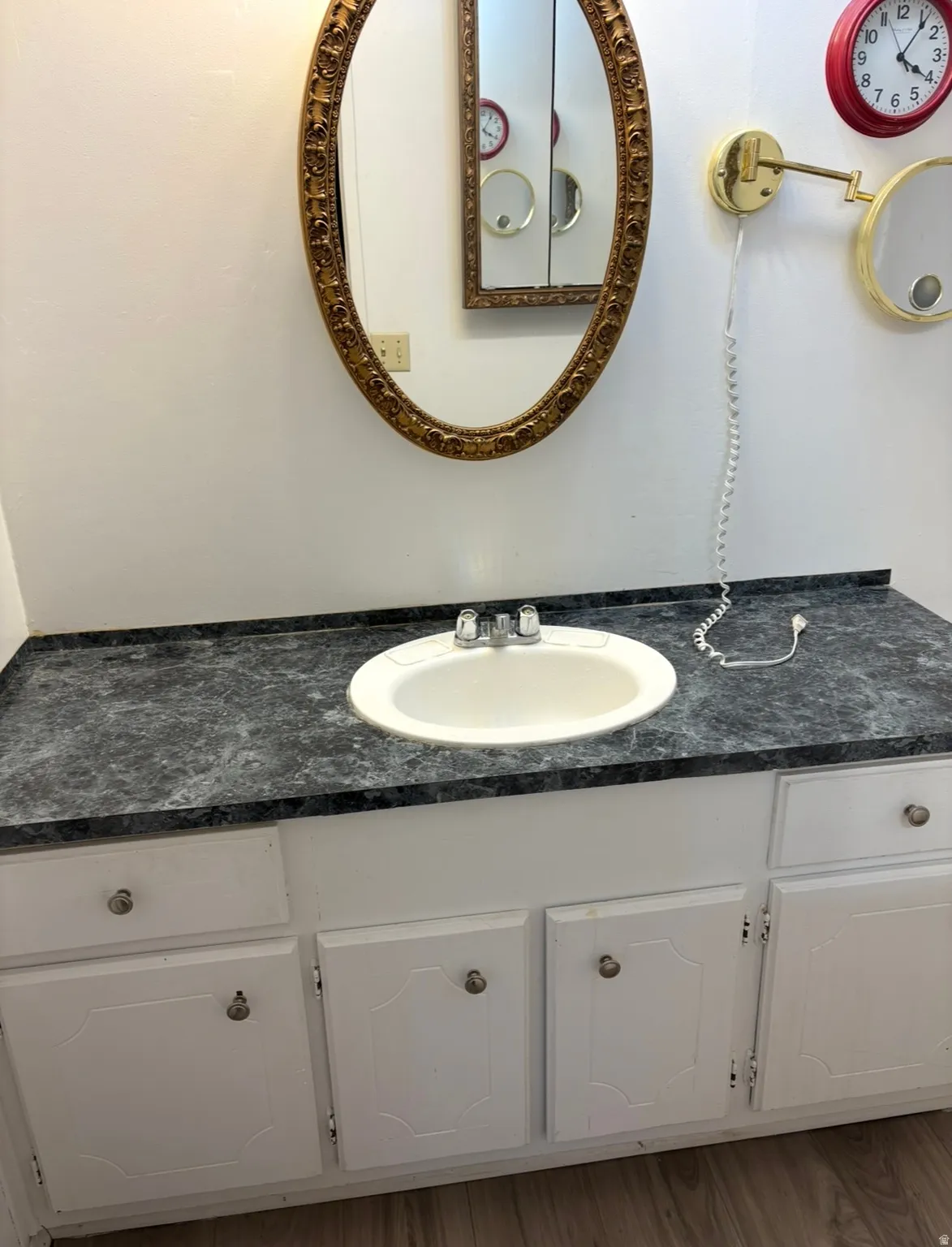 Bathroom featuring vanity and light wood finished floors
