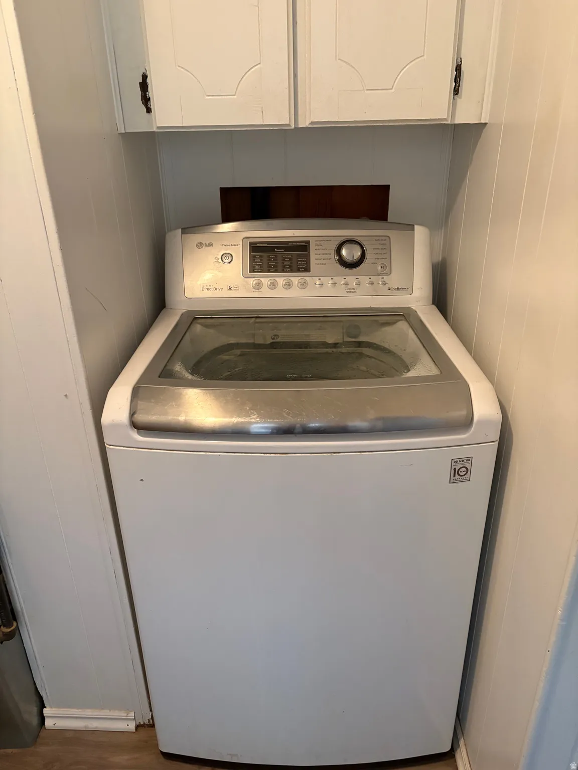 Laundry room featuring washer / clothes dryer and cabinet space