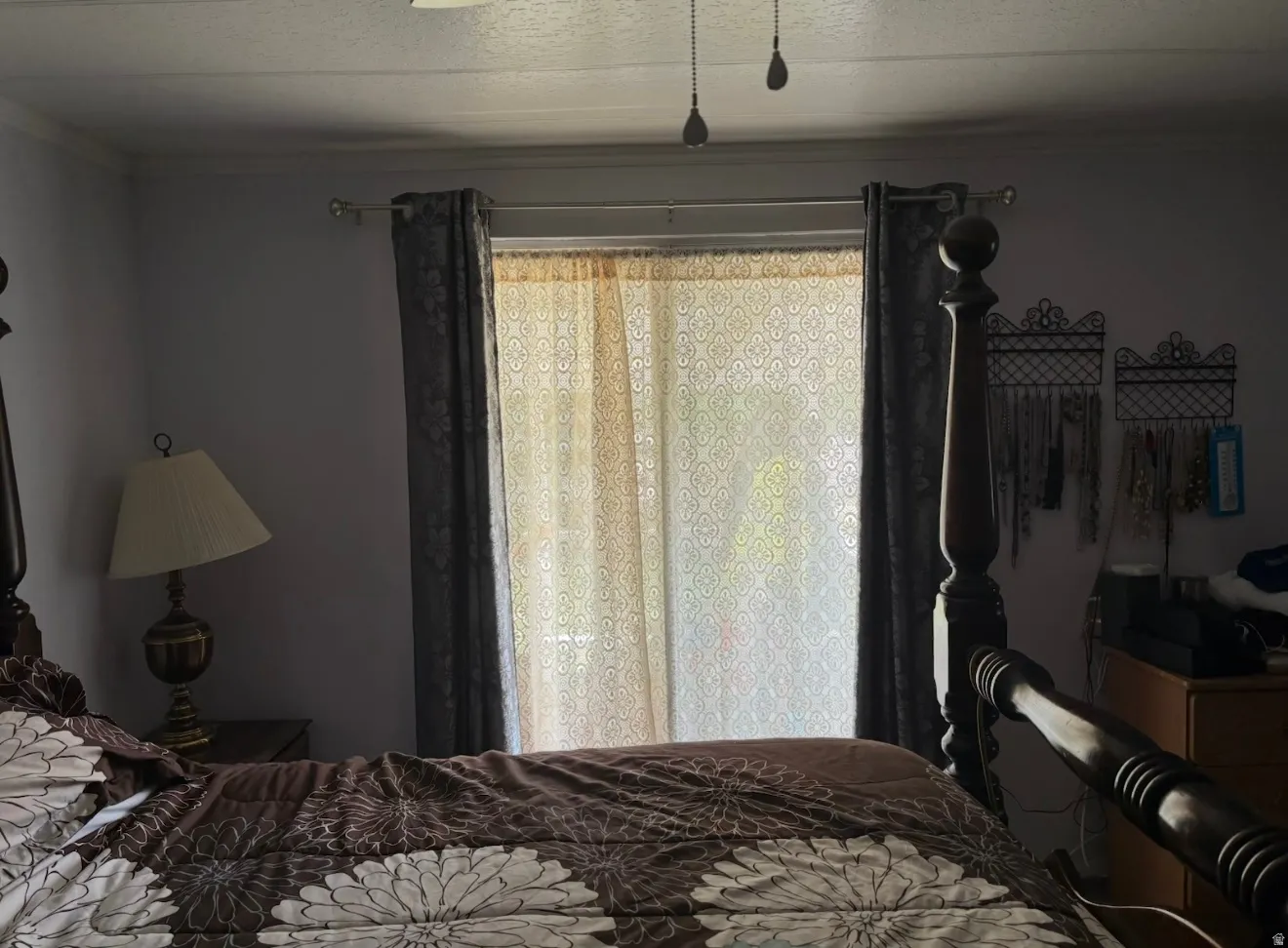 Bedroom with ornamental molding and a textured ceiling