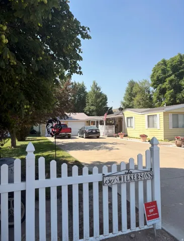 View of front of house featuring a fenced front yard and driveway