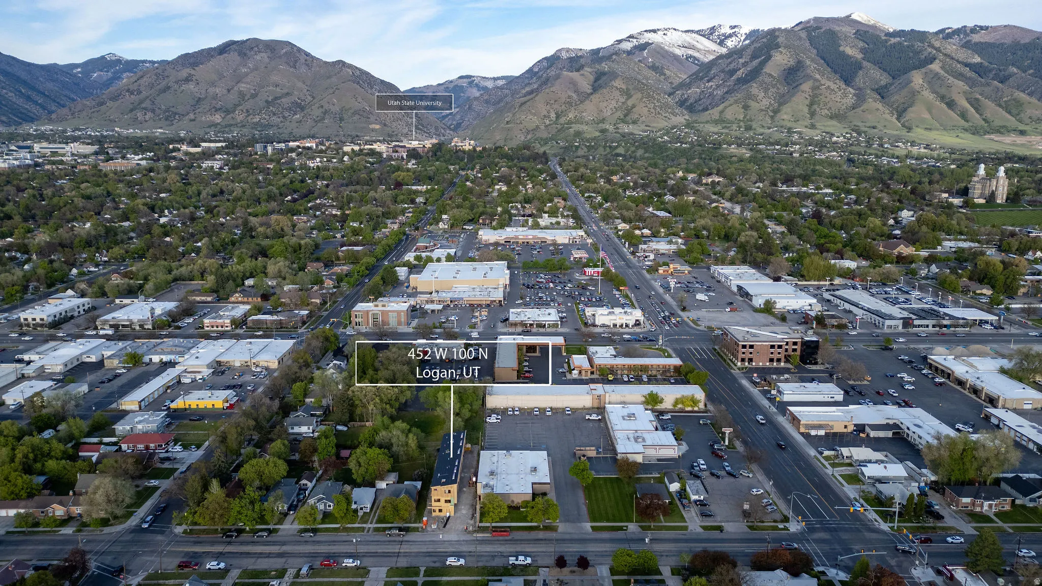 Aerial overview of property's location featuring a mountainous background and property parcel outlined