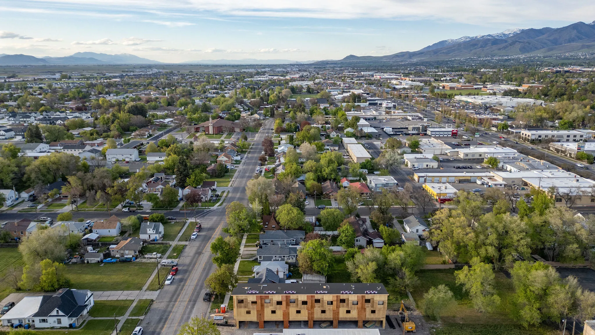 Aerial overview of property's location featuring a mountainous background