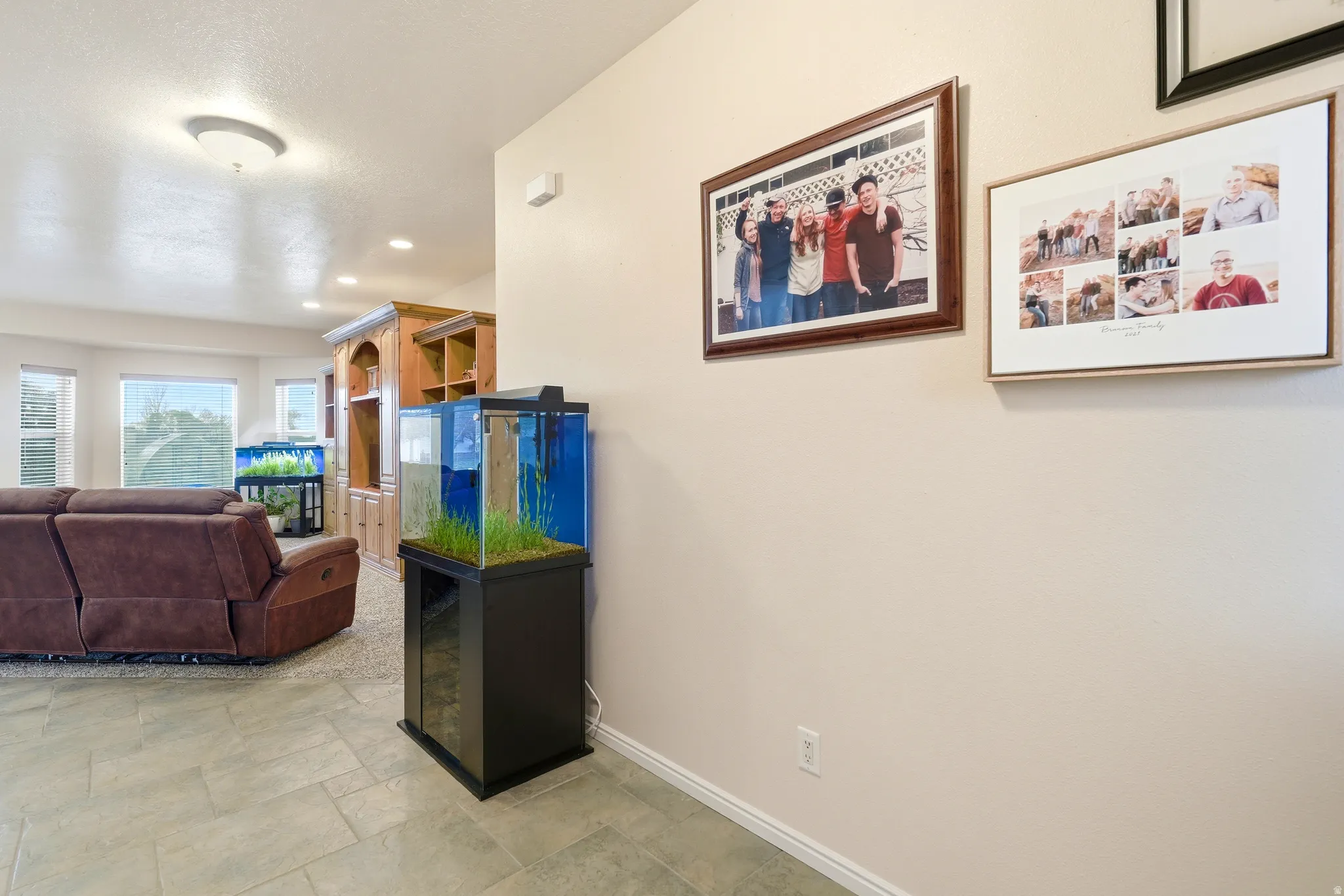 Living room with recessed lighting and stone finish flooring
