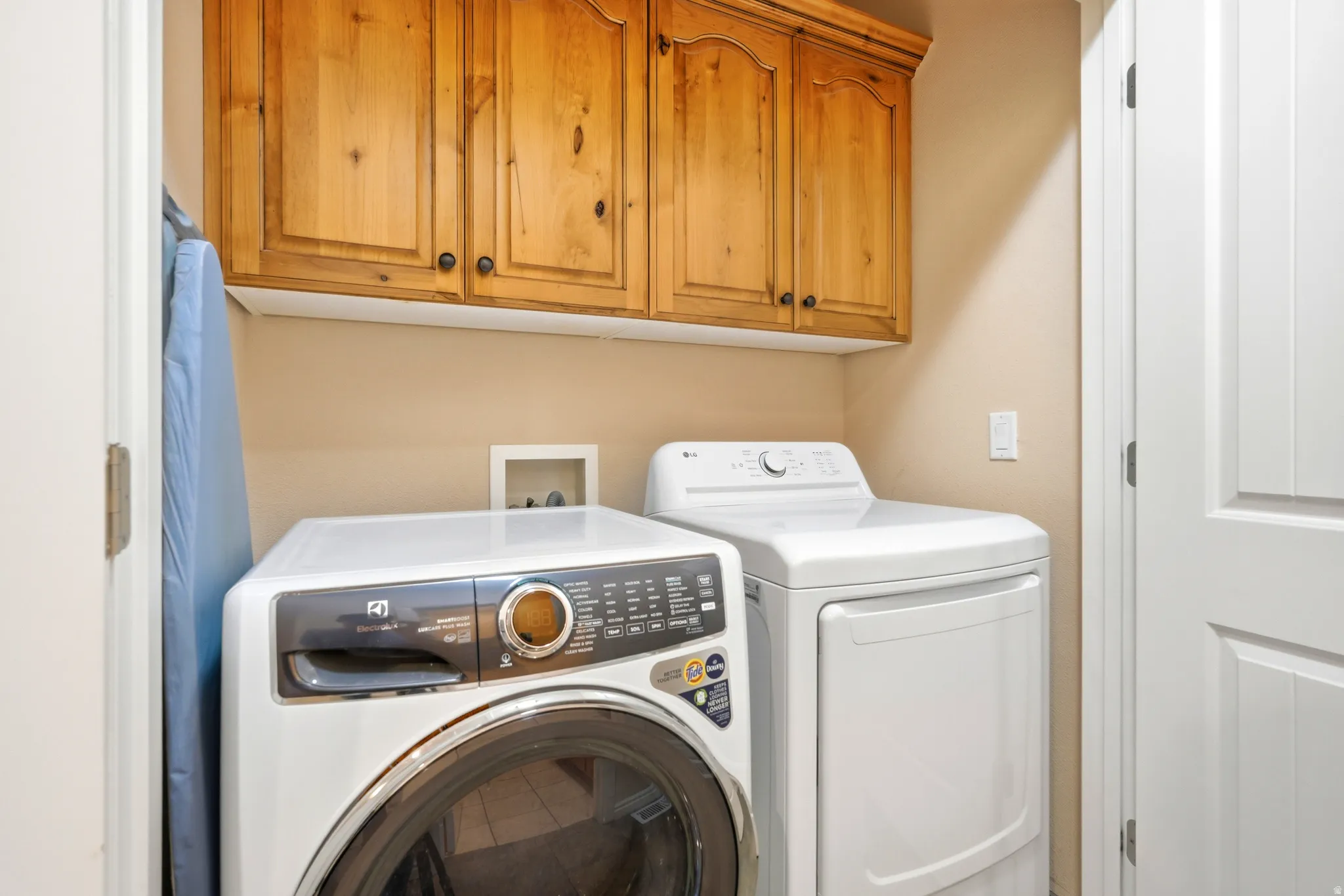 Laundry room featuring separate washer and dryer and cabinet space