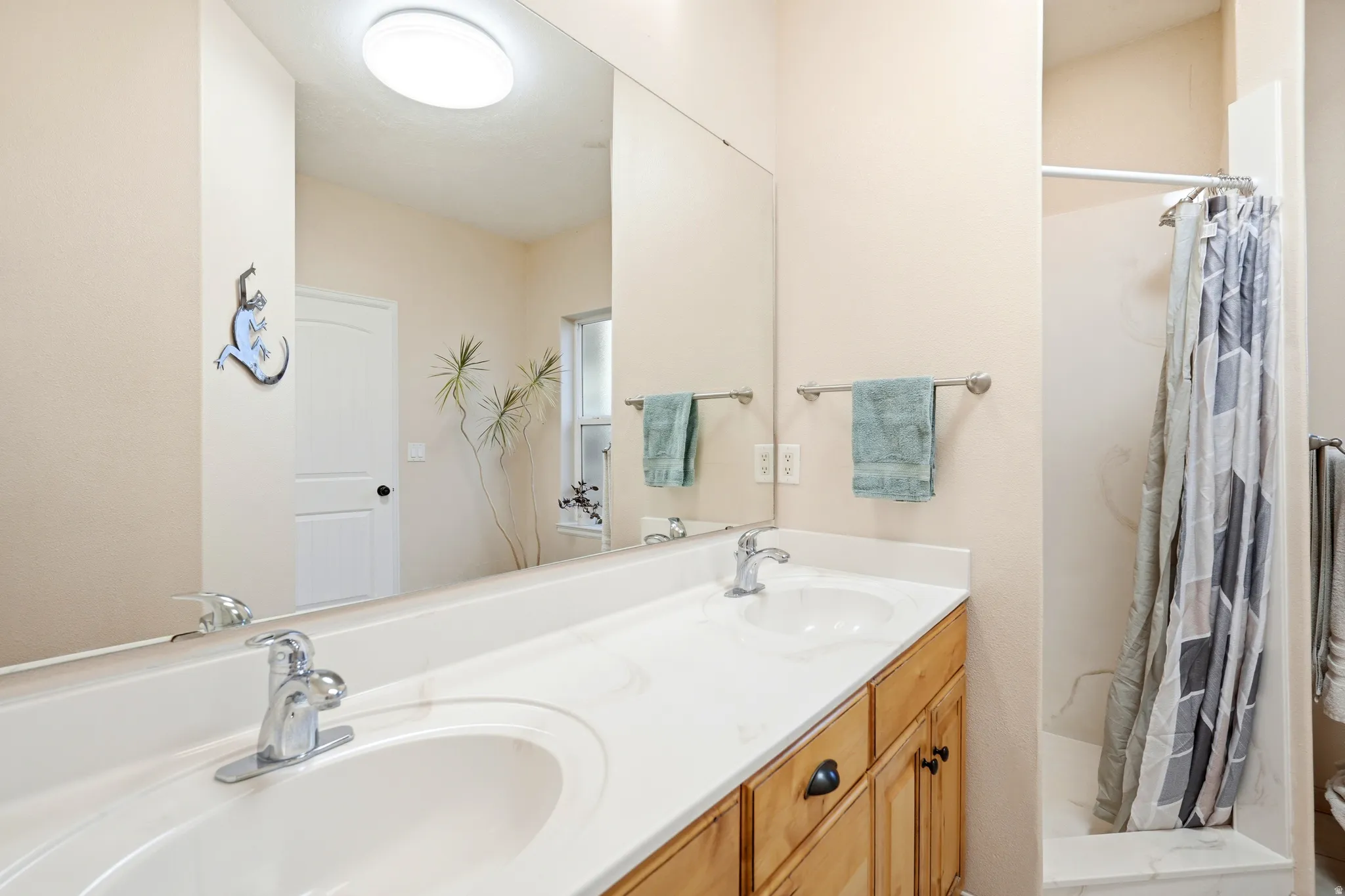 Bathroom with double vanity and a shower stall