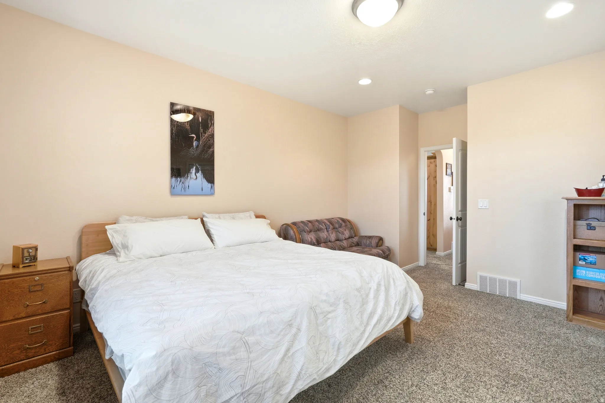 Bedroom with dark colored carpet and recessed lighting