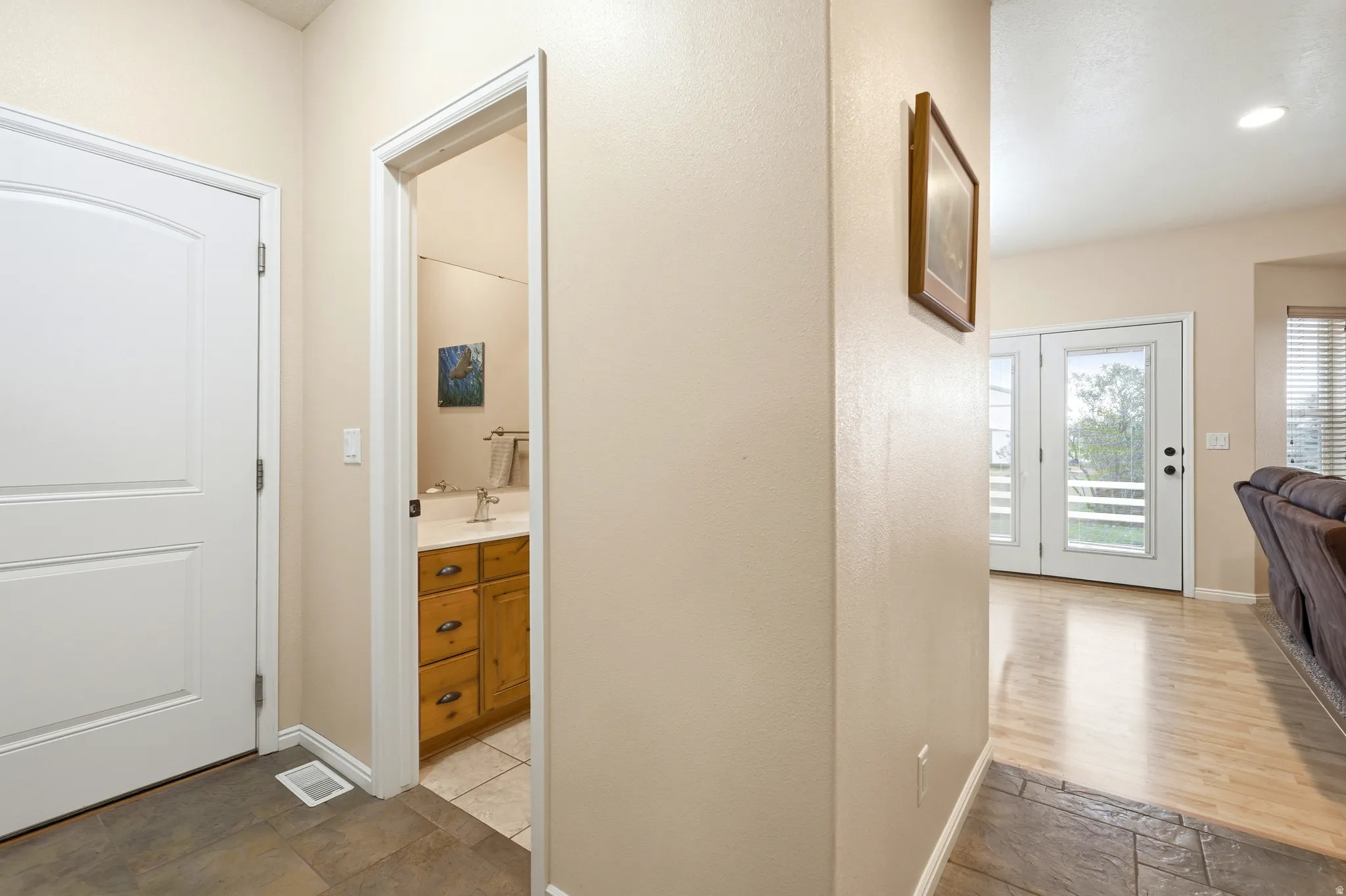 Hall with baseboards and light stone finish floors