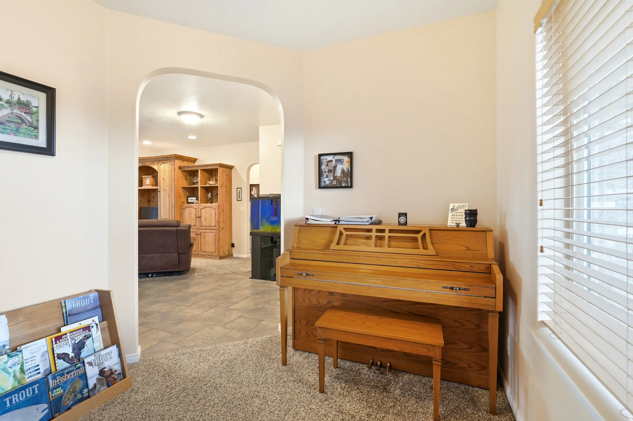 Office area with light colored carpet and arched walkways