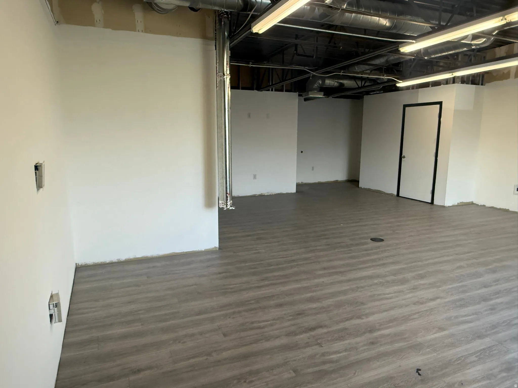 Spare room with dark wood-type flooring