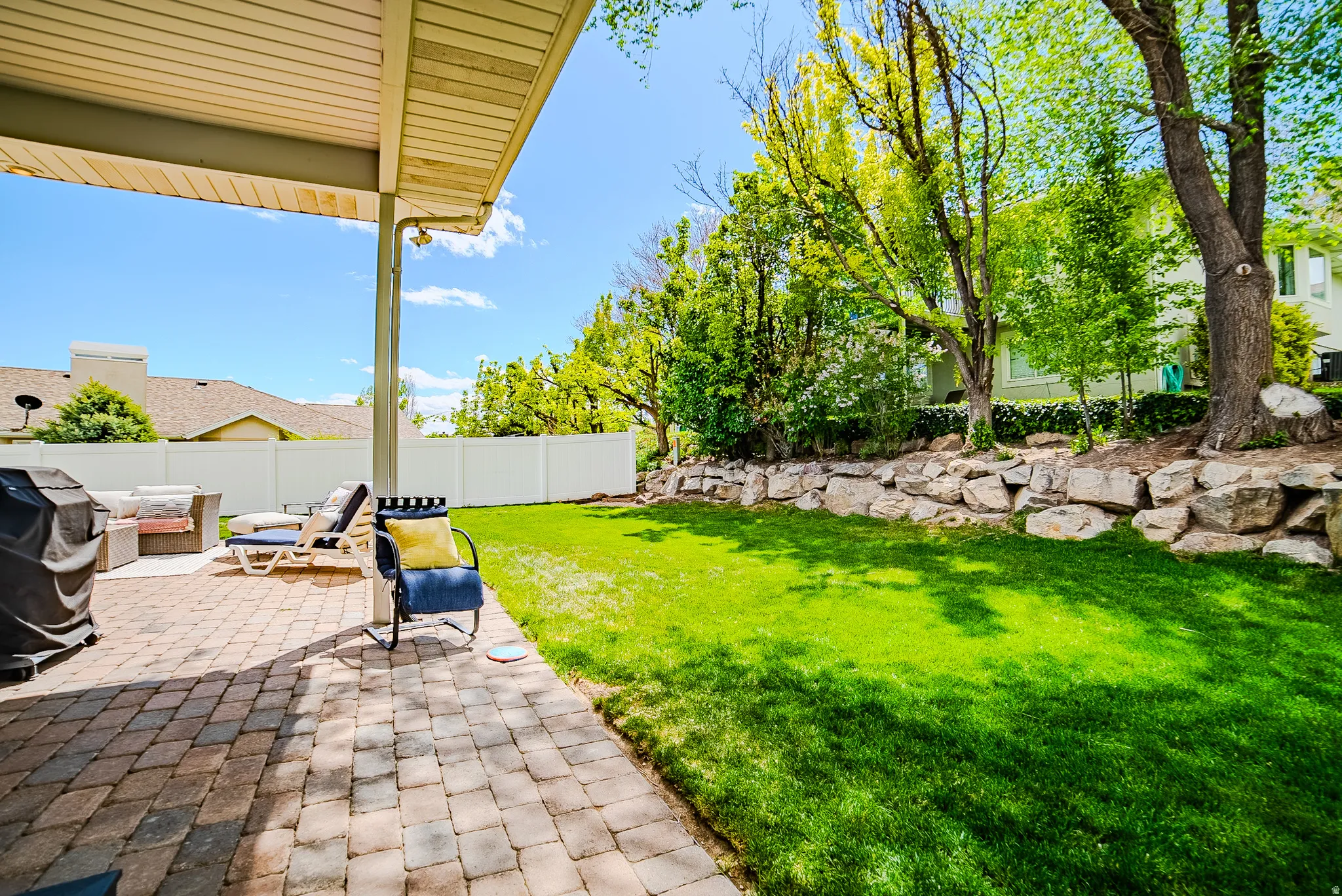 Fenced backyard featuring outdoor furniture and a patio area