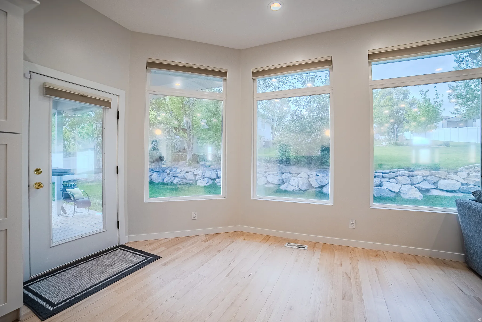 Entryway with hardwood / wood-style flooring and baseboards