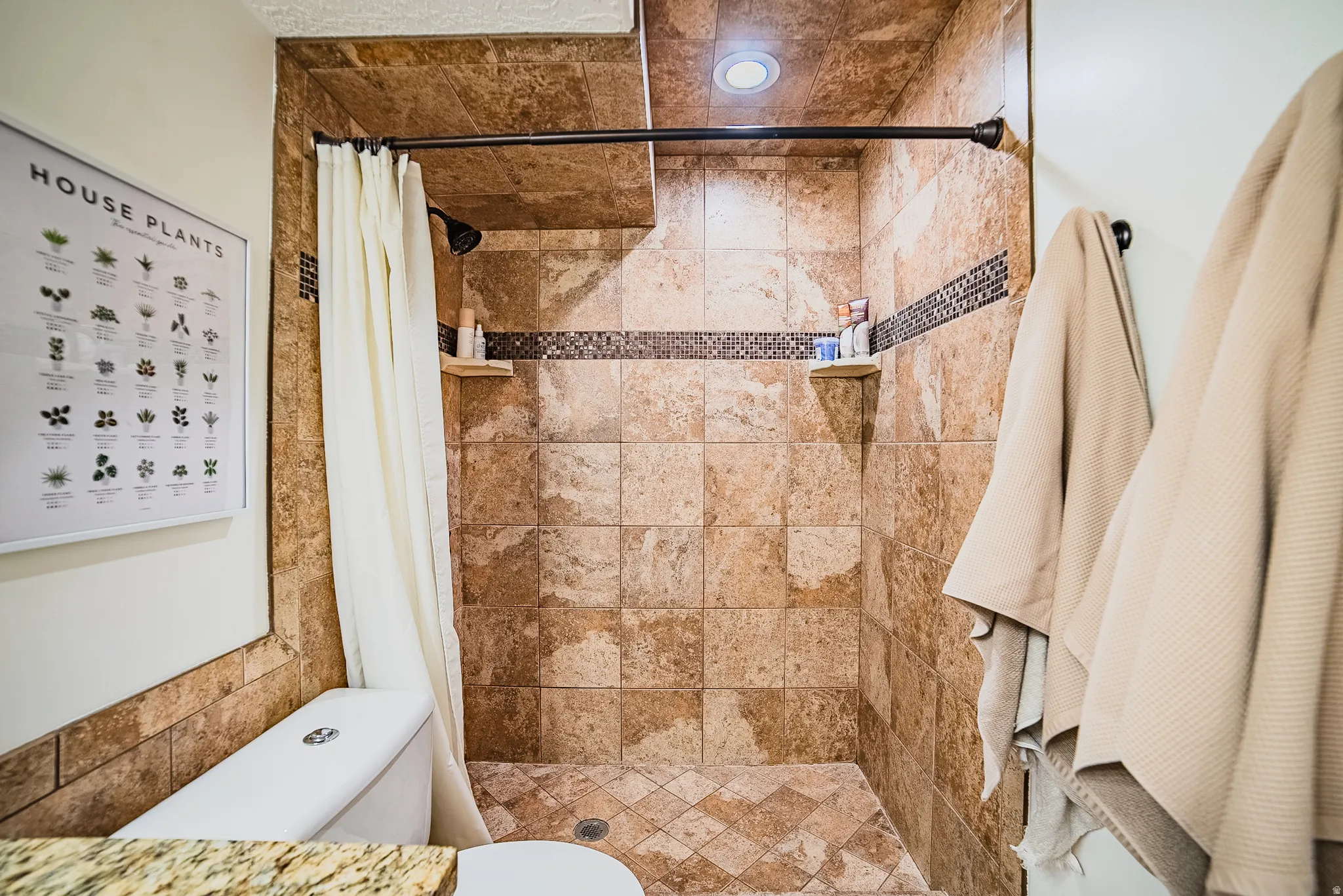 Bathroom with a shower stall and recessed lighting