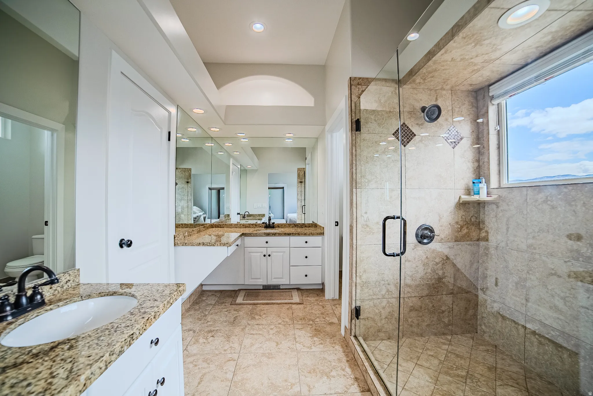 Bathroom with vanity, a stall shower, and recessed lighting