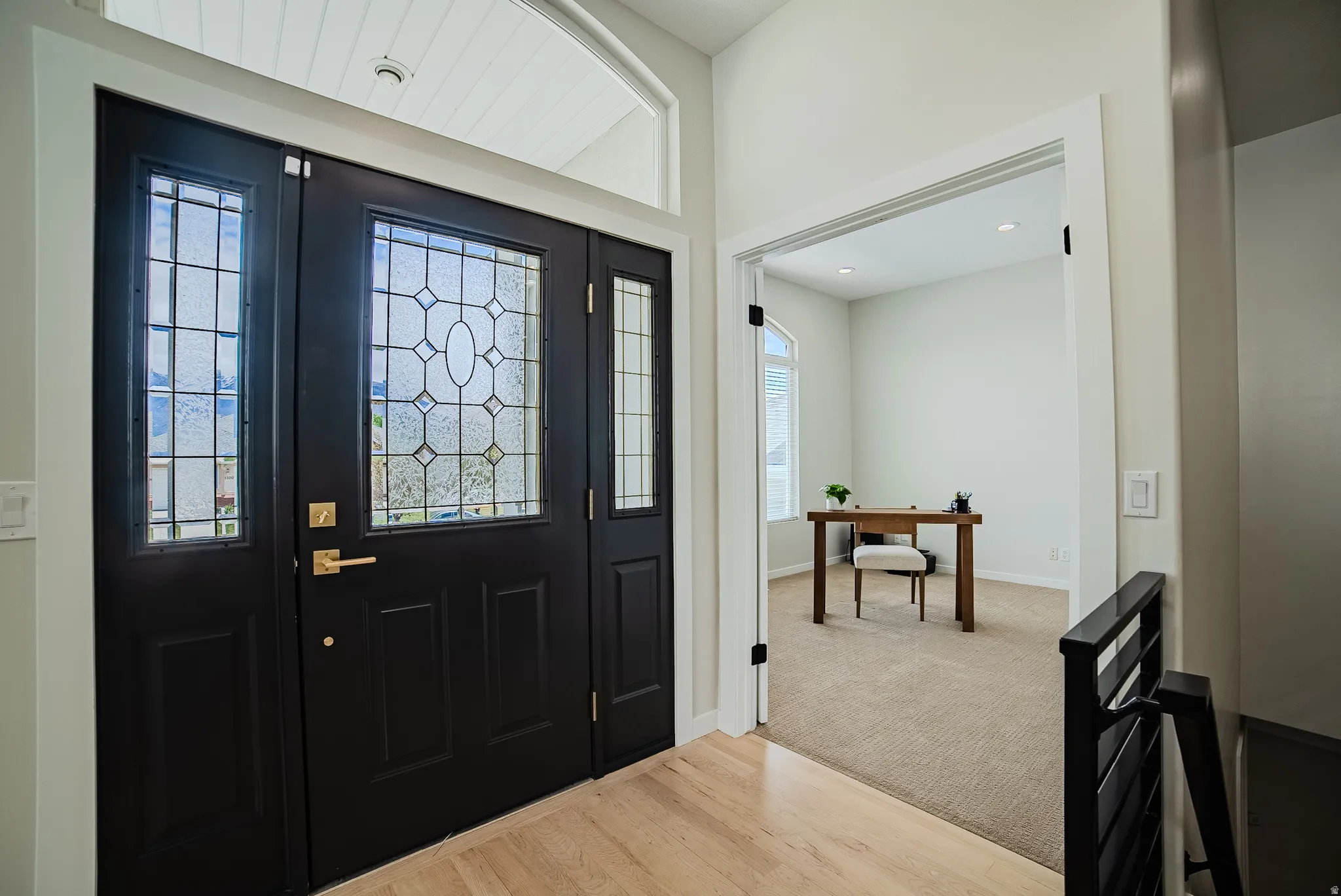 Foyer entrance featuring light wood finished floors and baseboards