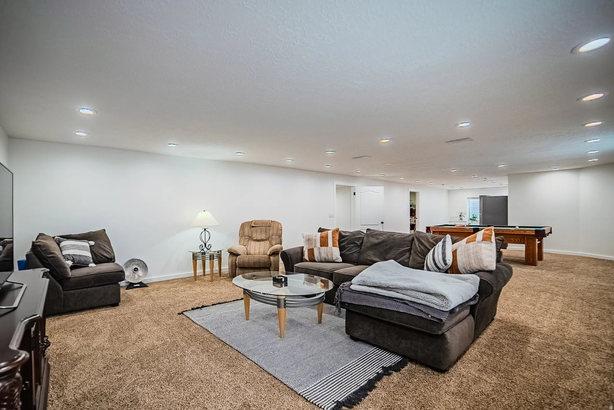 Living room with carpet floors, billiards table, and recessed lighting