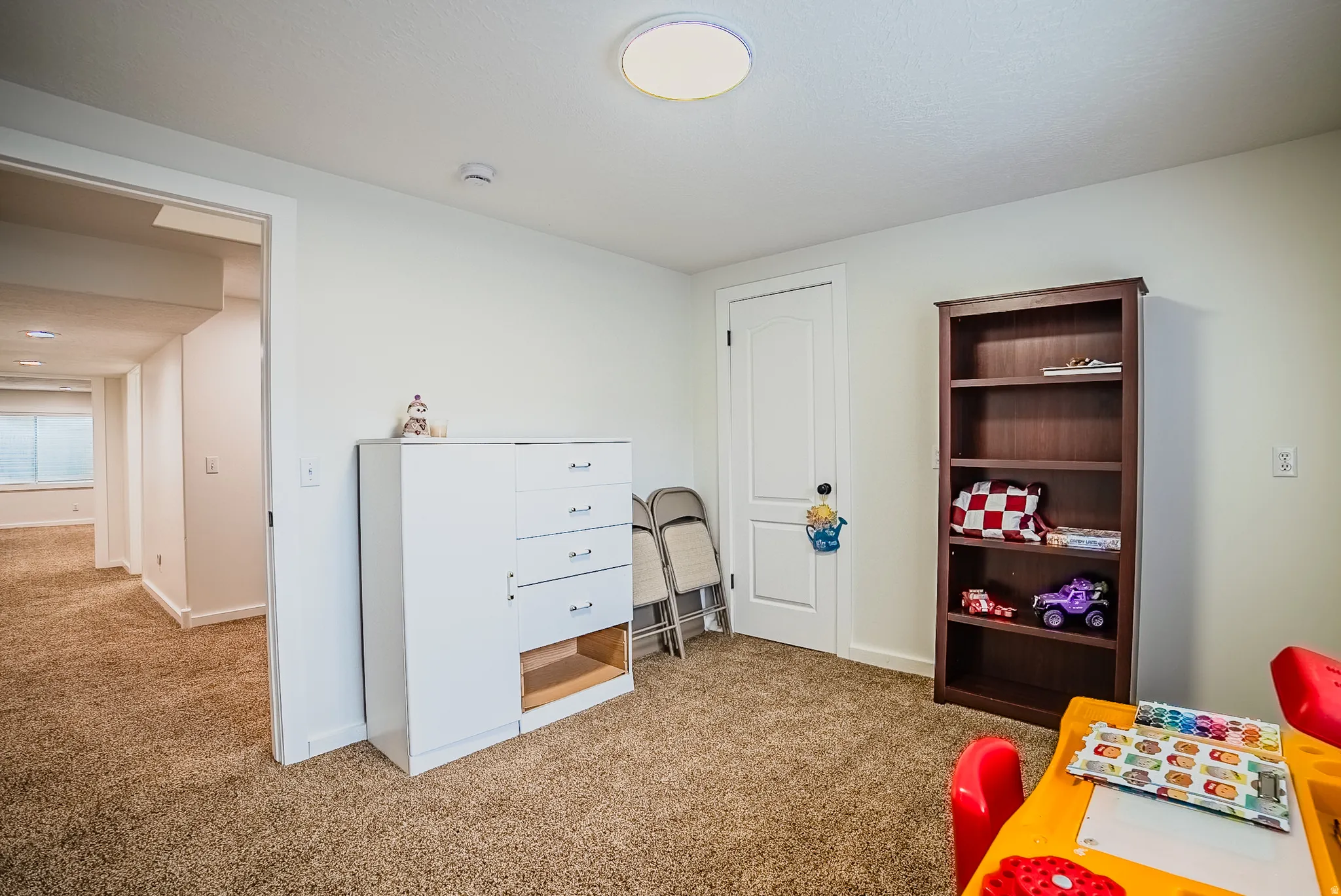 Bedroom featuring light carpet