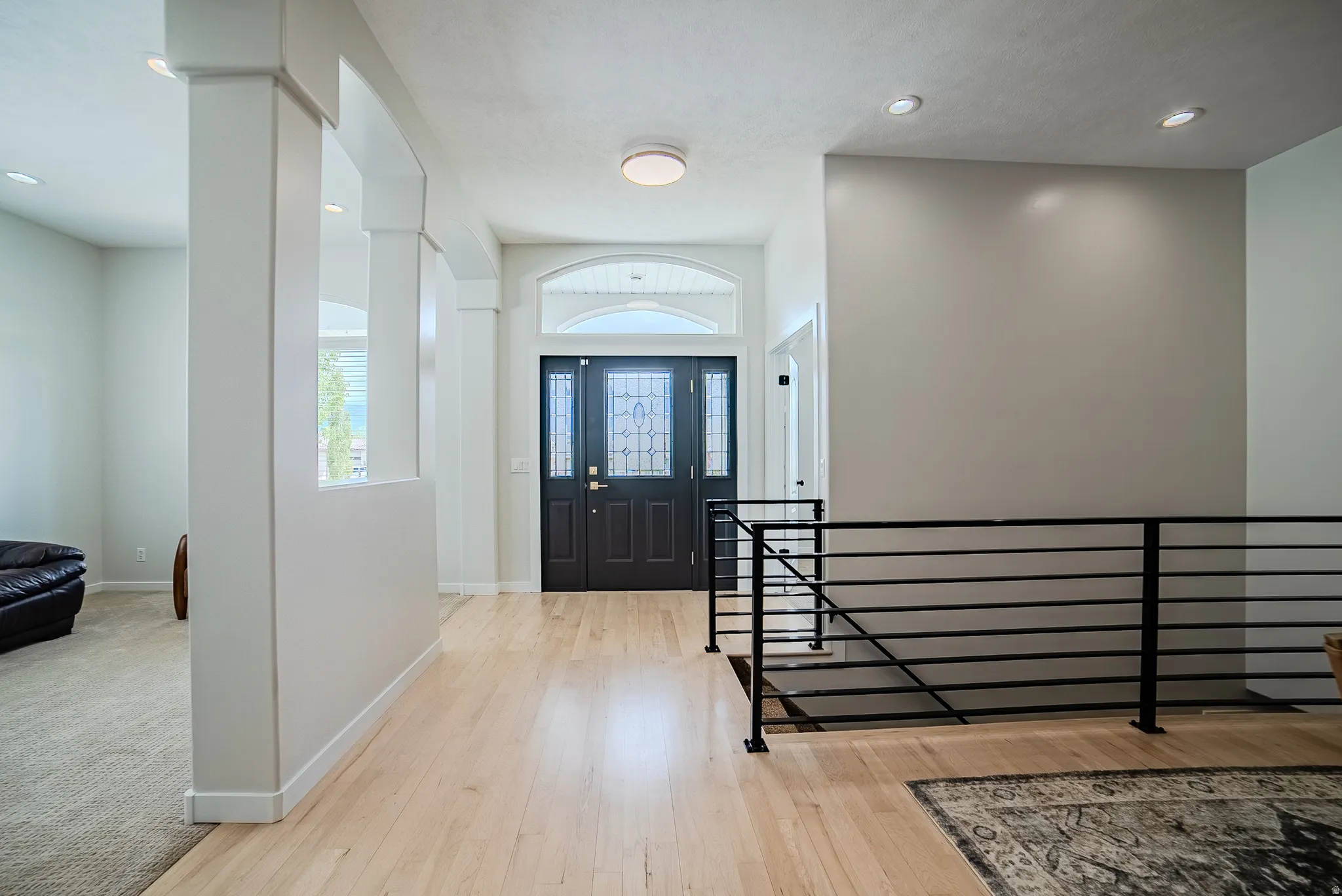 Entrance foyer with recessed lighting and light wood-style flooring
