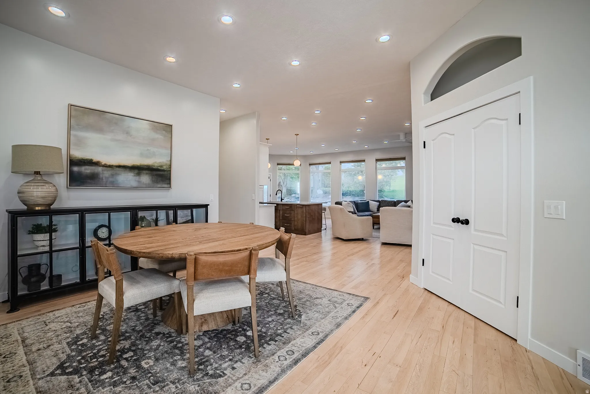 Dining room with light wood-style flooring and recessed lighting