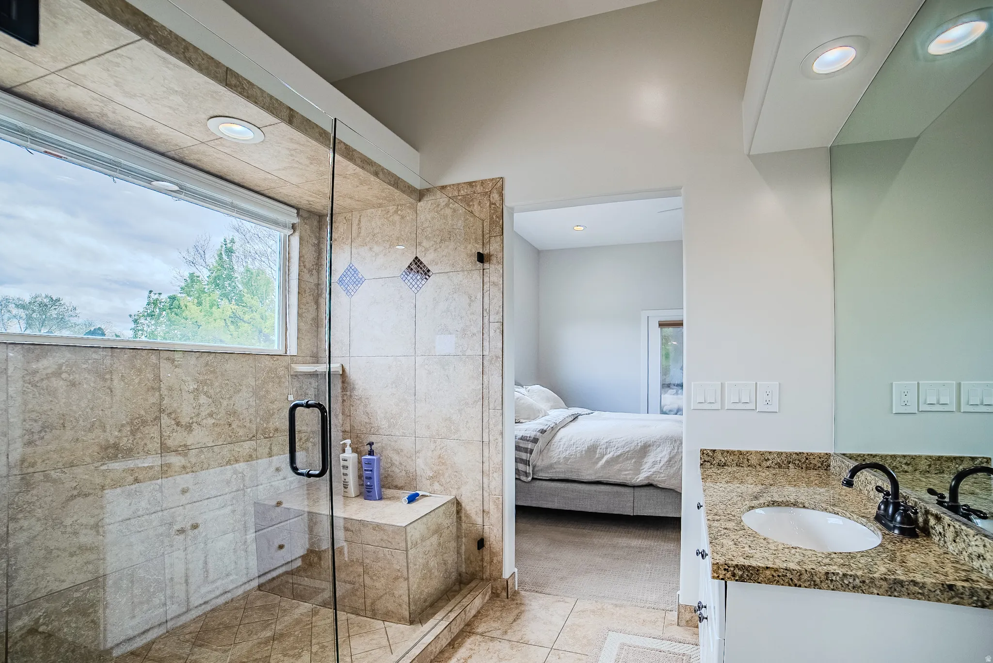 Full bath with vanity, a shower stall, connected bathroom, healthy amount of natural light, and recessed lighting