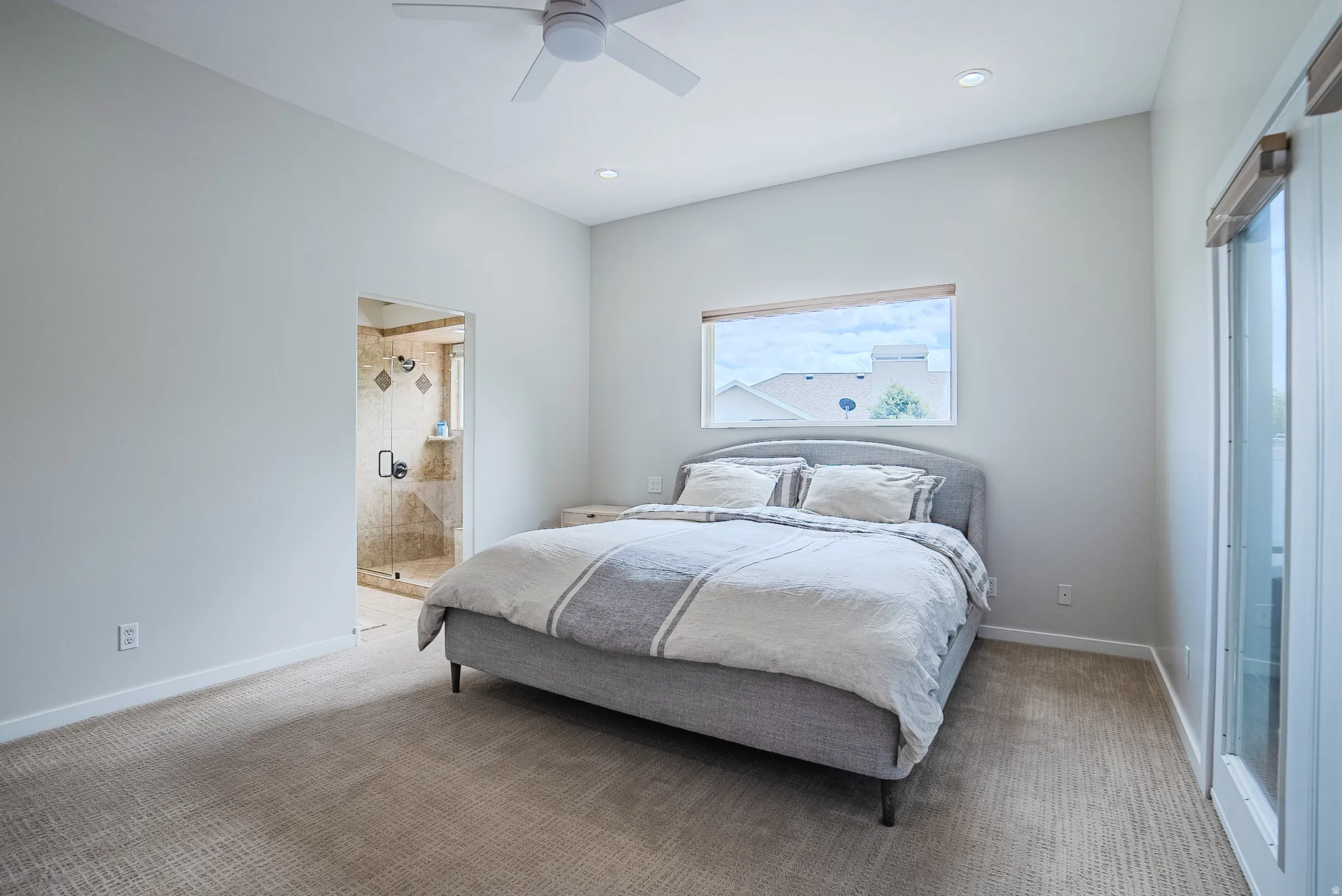 Carpeted bedroom featuring ensuite bath, ceiling fan, and recessed lighting