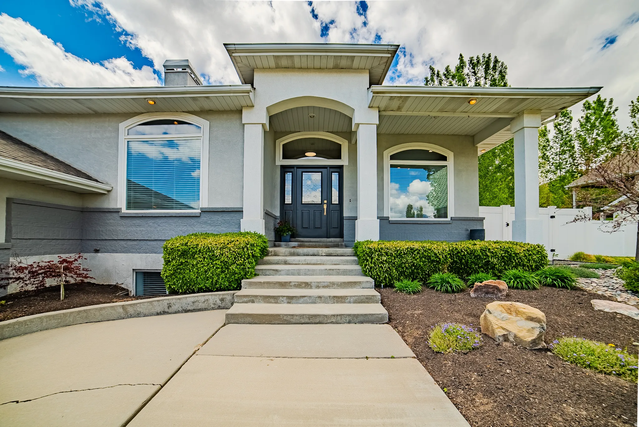 Doorway to property featuring stucco siding and a chimney