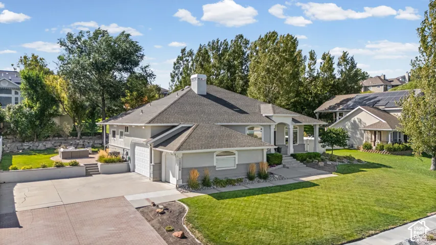 Contemporary exterior with a multi-car driveway, attached garage, and a covered front entry