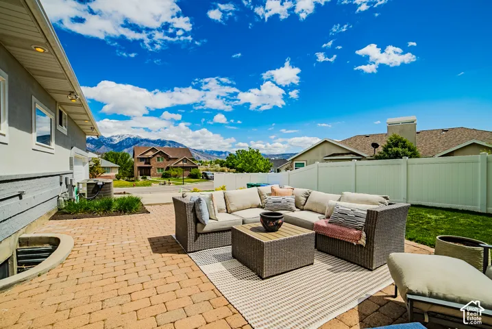 View of patio with a mountain view, outdoor lounge area, and a residential view