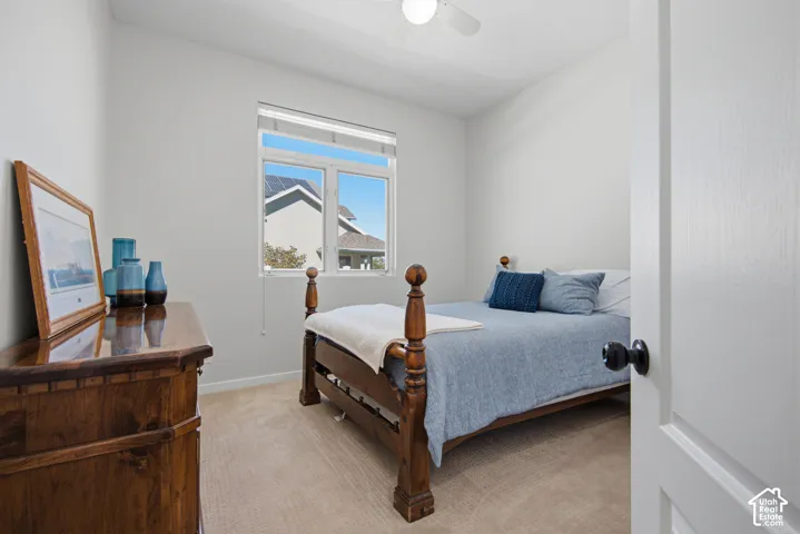 Neutral wall paint, window with blinds, carpeted flooring, and a ceiling fan