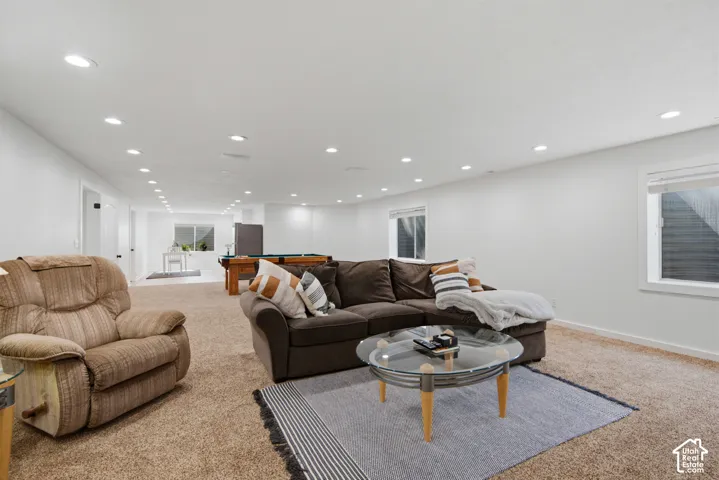 Recessed ceiling lighting, white walls, and a window provide illumination