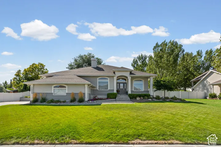 Stucco exterior with a multi-level roofline, arched windows, and a covered entry