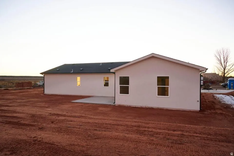 Back of house featuring stucco siding
