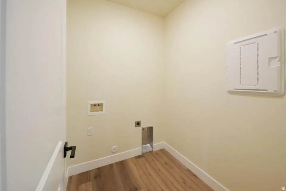 Laundry room with light wood-style floors, washer hookup, and hookup for an electric dryer