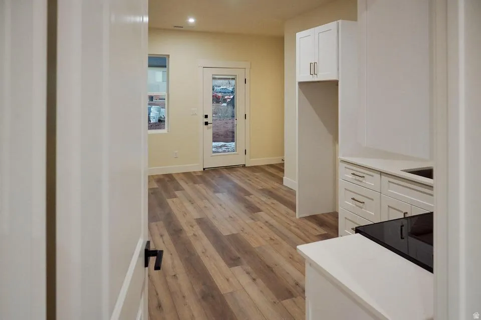Corridor featuring light wood finished floors and recessed lighting