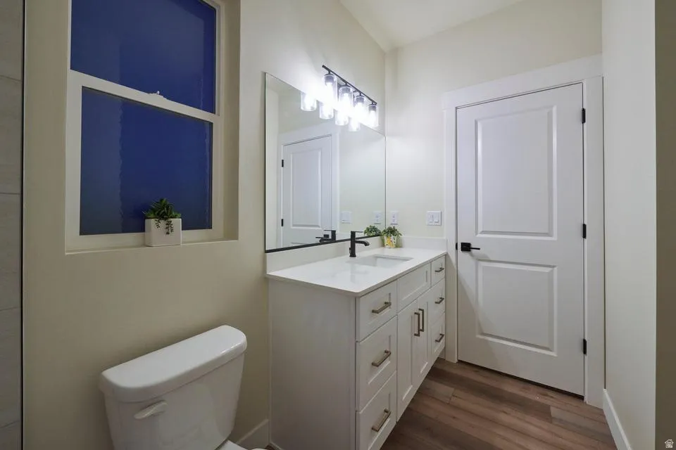 Bathroom with vanity and dark wood-style floors