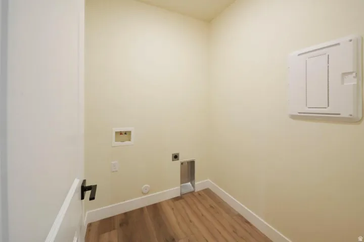 Laundry room with light wood-style floors, washer hookup, and hookup for an electric dryer