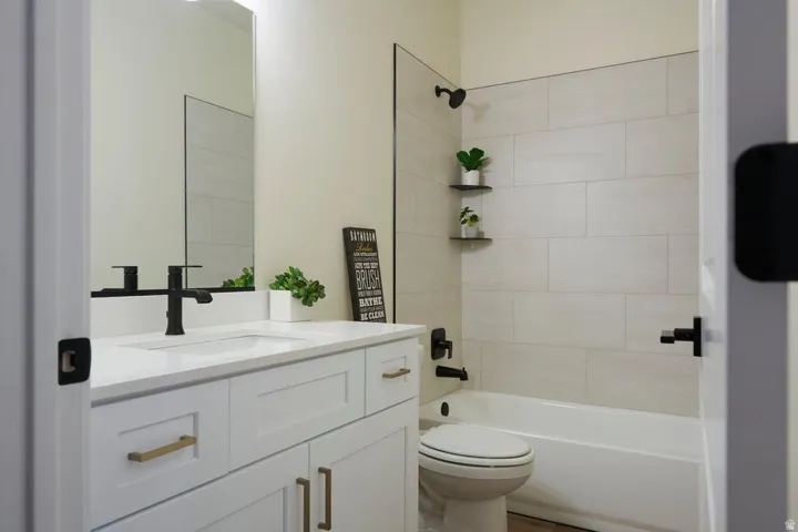 Bathroom with vanity and shower / bath combination