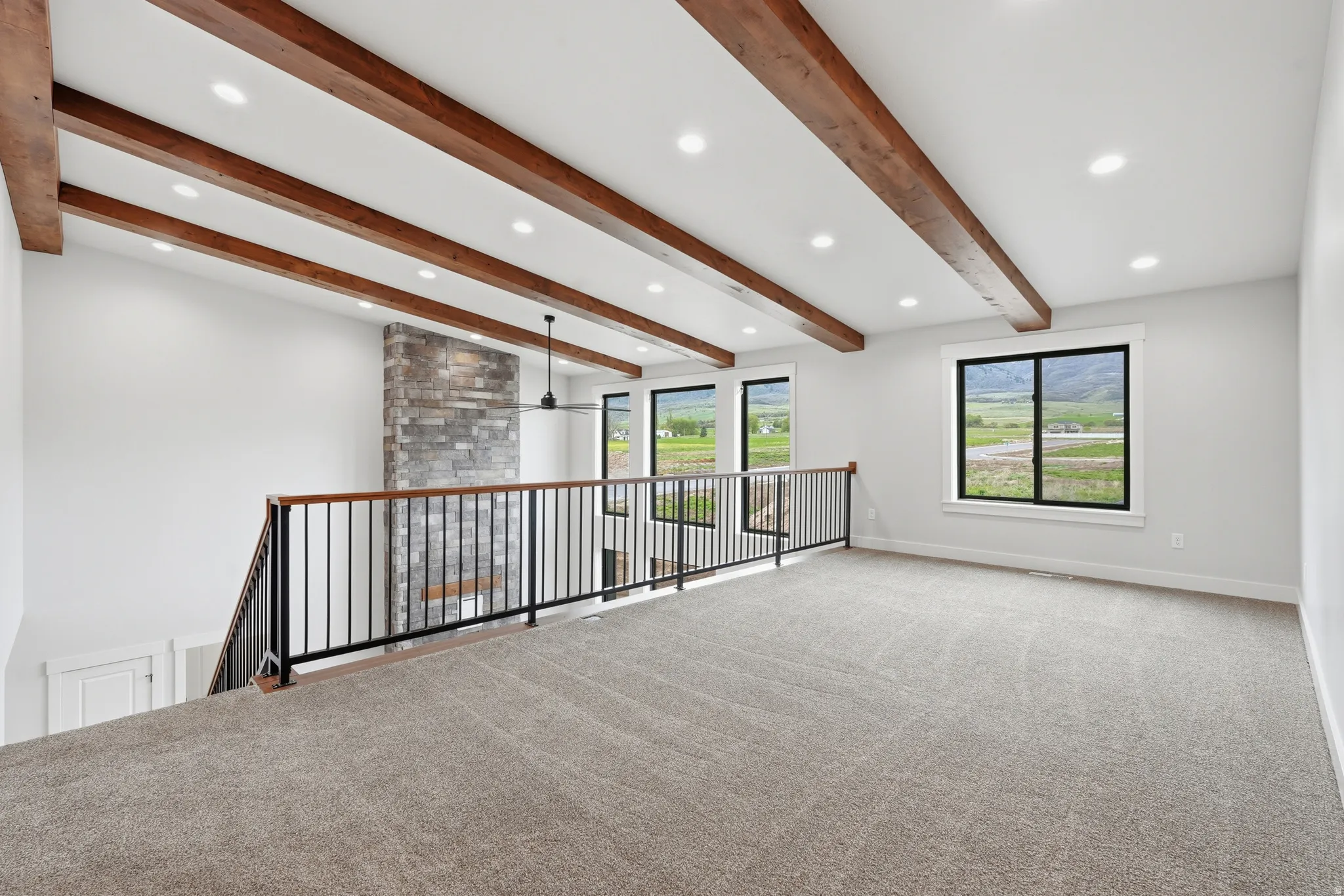 Spare room with carpet, beamed ceiling, recessed lighting, and ceiling fan