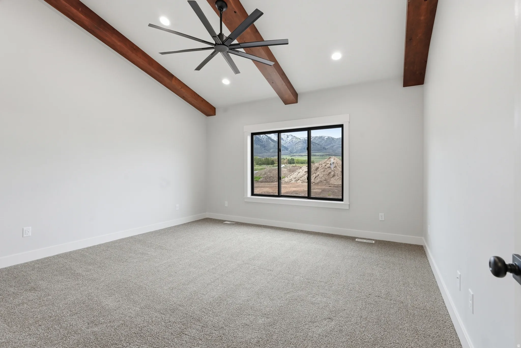 Unfurnished room with light colored carpet, recessed lighting, vaulted ceiling with beams, and ceiling fan