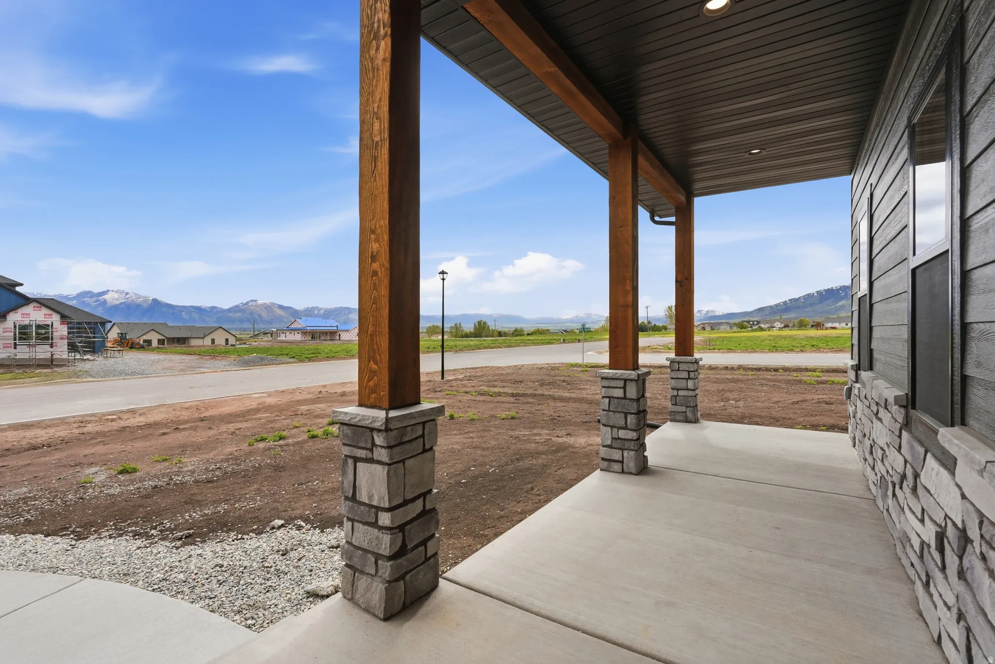 Covered porch featuring a mountain view
