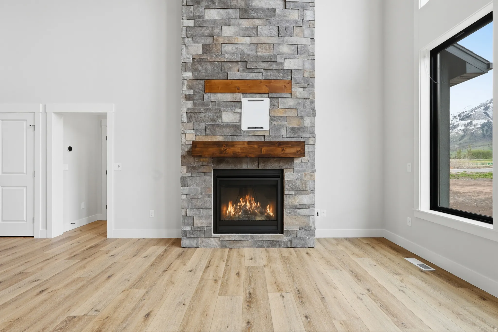 Detailed view of wood finished floors and a fireplace