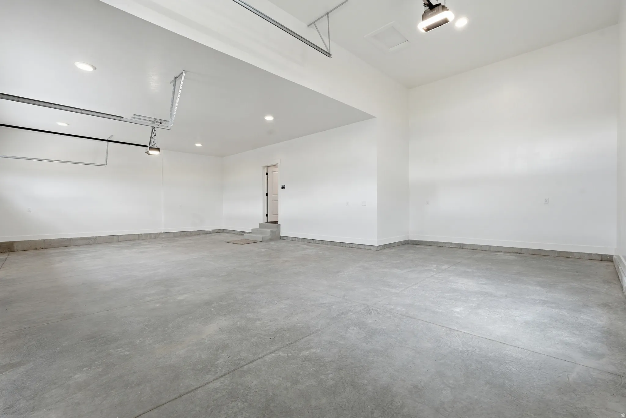 Garage with recessed lighting and a garage door opener