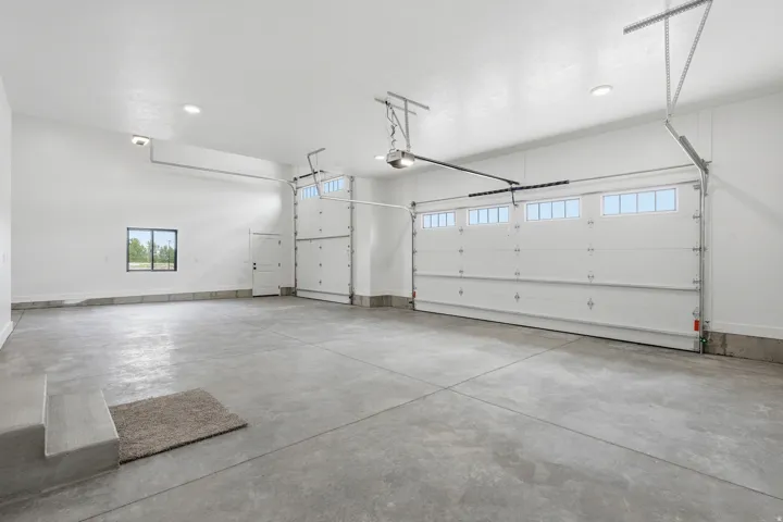 Garage featuring a garage door opener and recessed lighting
