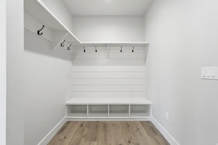 Mudroom with light wood-type flooring and baseboards