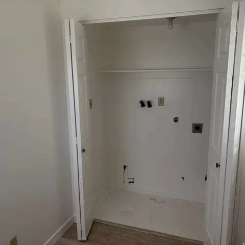 Laundry area featuring electric dryer hookup, washer hookup, light wood-type flooring, and gas dryer hookup