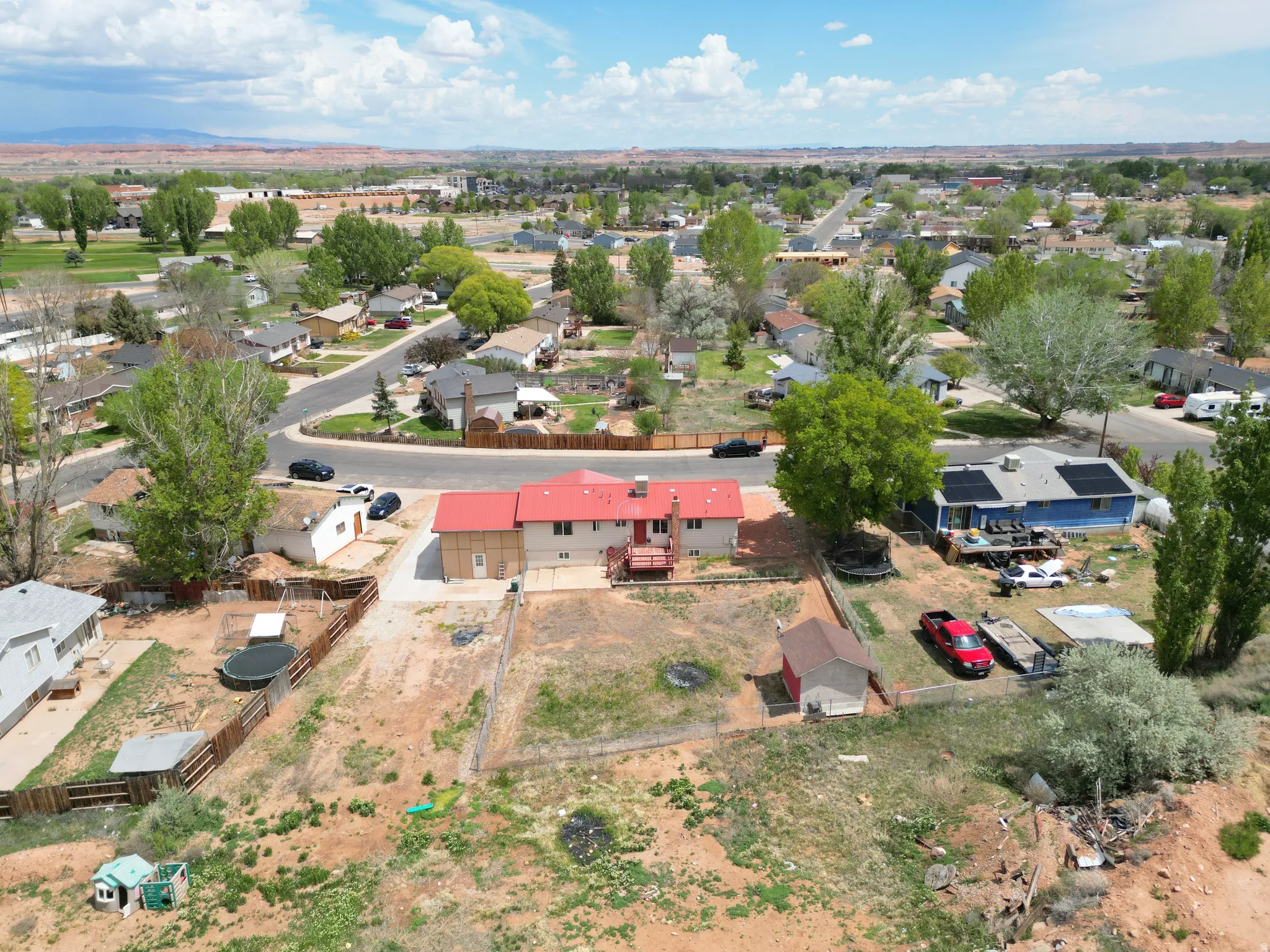 Aerial overview of property's location with nearby suburban area looking east back of yard.
