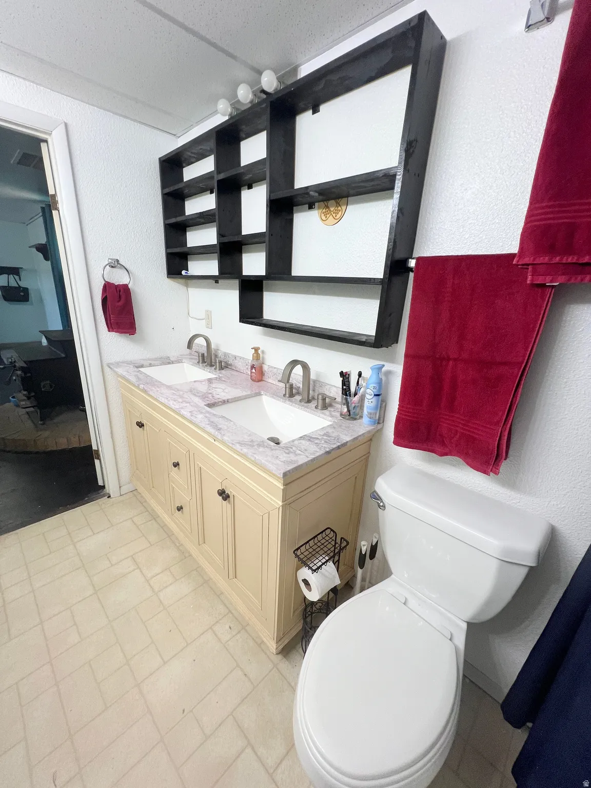 Ensuite bathroom with double vanity and a textured wall
